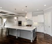 Grey Island  with White Kitchen Cabinets in this Open Floor plan built by Waterford Homes in Sandy Springs